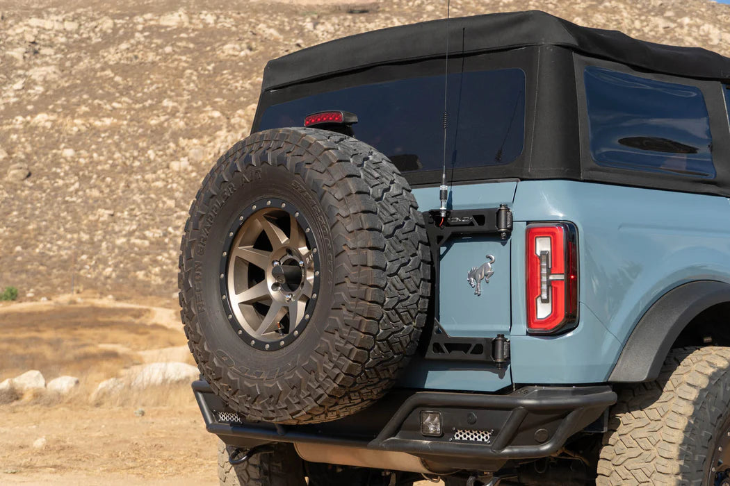 DV8 Offroad Tire Carrier | Fits 2021–2025 Ford Bronco | Heavy-Duty Tailgate Reinforcement | Includes 3rd Brake Light Extension