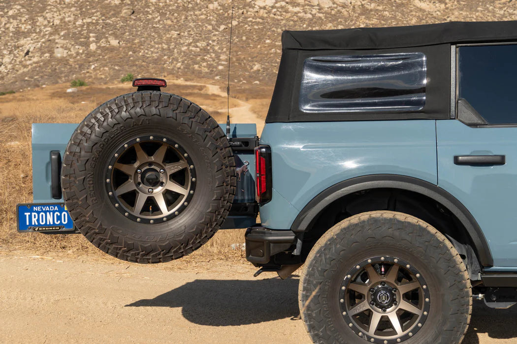 DV8 Offroad Tire Carrier | Fits 2021–2025 Ford Bronco | Heavy-Duty Tailgate Reinforcement | Includes 3rd Brake Light Extension