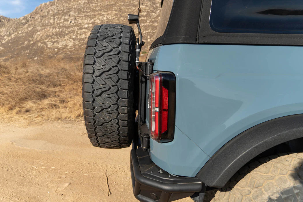 DV8 Offroad Tire Carrier | Fits 2021–2025 Ford Bronco | Heavy-Duty Tailgate Reinforcement | Includes 3rd Brake Light Extension